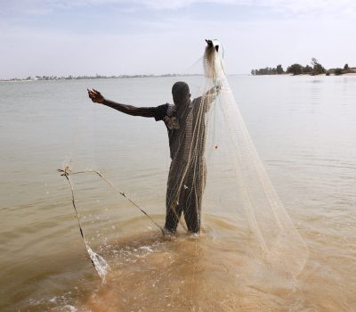 fisherman-with-net-river